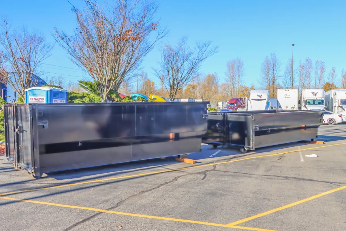 Professional dumpster rental service with roll-off container on residential driveway in North Olmsted
